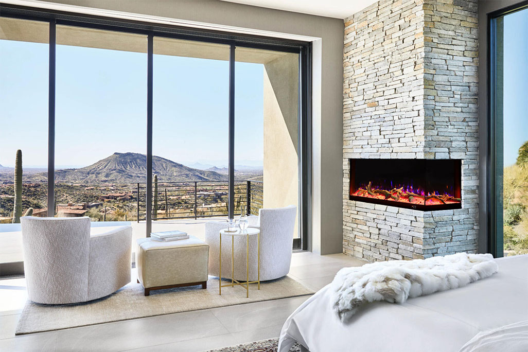 An interior shot of a contemporary hotel room, highlighting a built-in L-shaped electric fireplace. This stylish and space-saving corner fireplace seamlessly integrates into the wall, offering a clean, modern look while creating a comfortable and inviting atmosphere for guests.